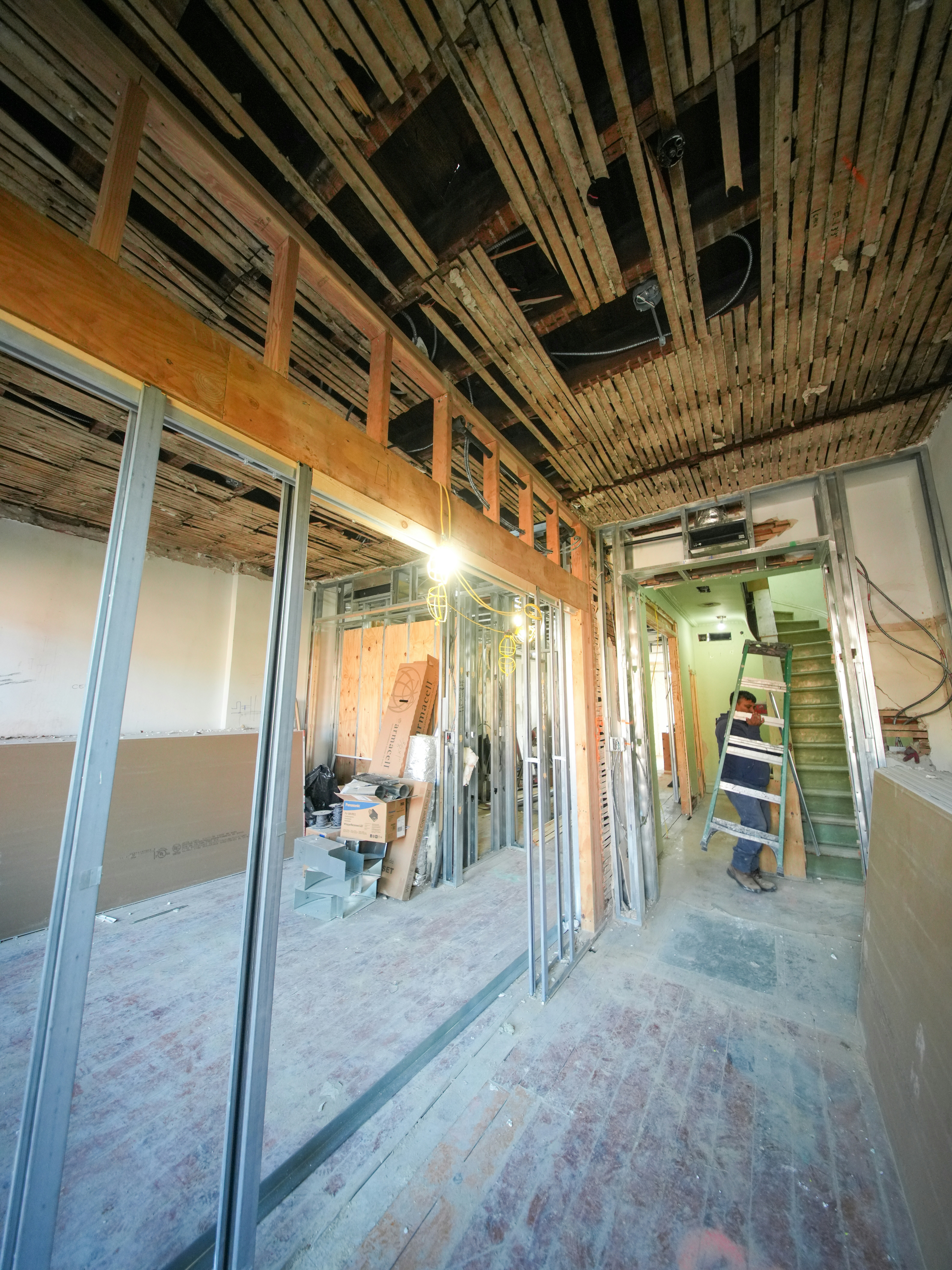 Interior renovation with metal stud framing and structural work in progress