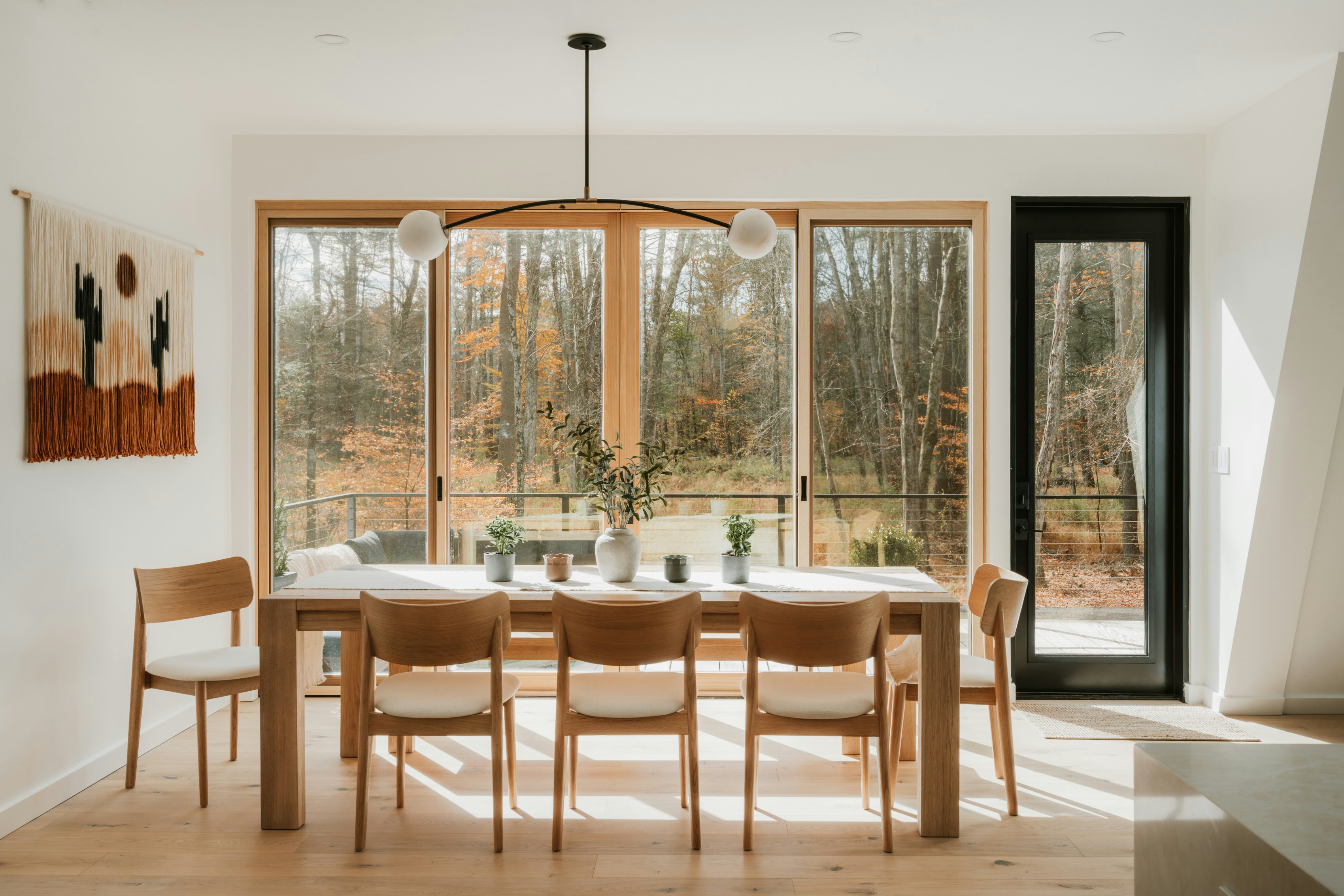 Completed open-plan dining room with oak furniture and floor-to-ceiling windows